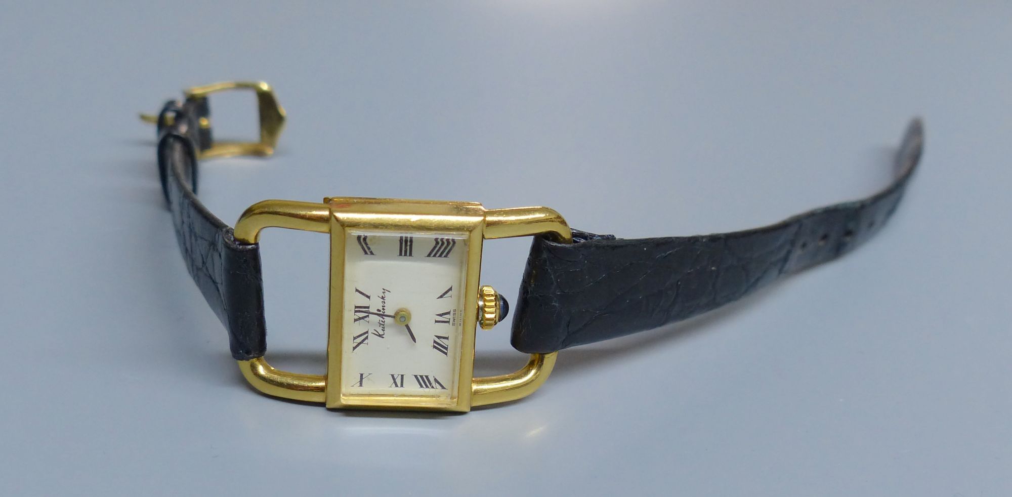 A ladys 18ct gold Kutchinsky manual wind rectangular dial wrist watch, with Ebel movement, on associated leather strap,